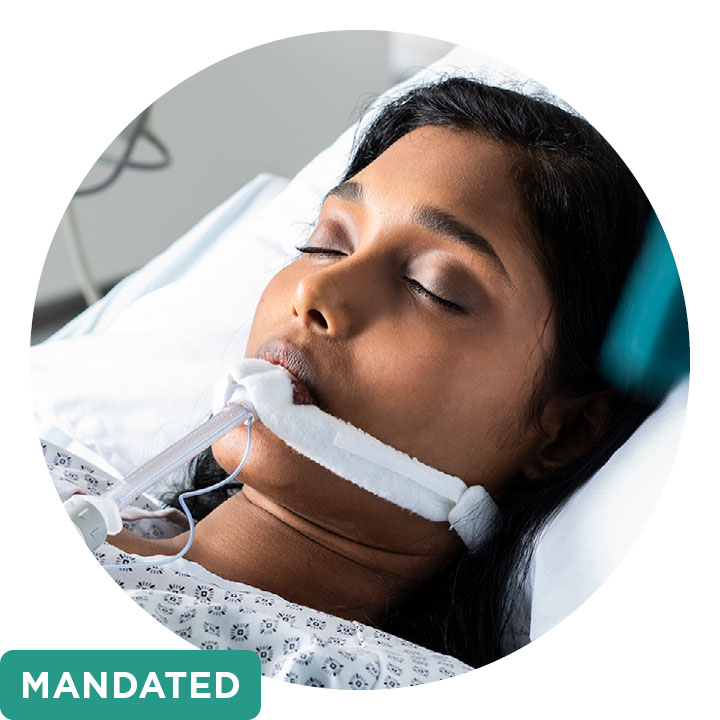 A female patient from the shoulders up, intubated in hospital plus a green text box stating “mandated”