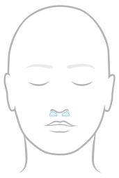 Line illustration of a face highlighting nasal pillow contact points at the nostrils