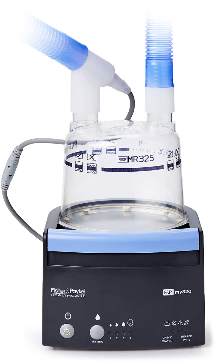 An F&P my820 respiratory humidifier with a clear water chamber and a blue breathing circuit attached