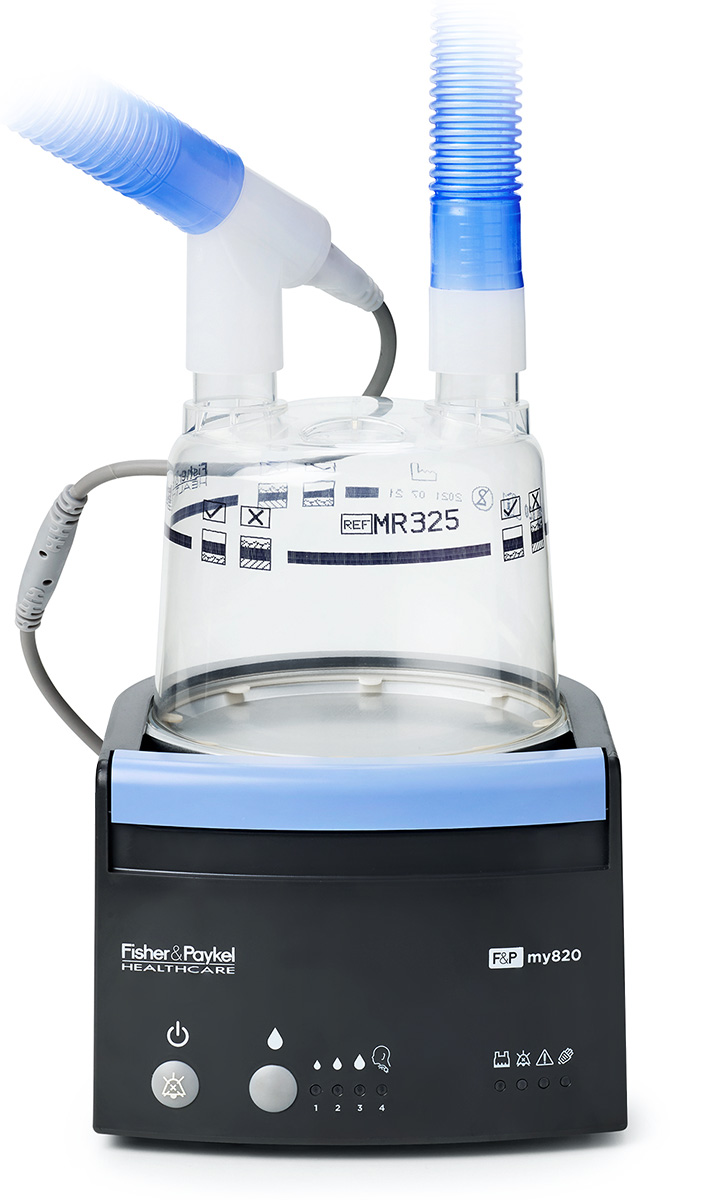 An F&P my820 respiratory humidifier with a clear water chamber and a blue breathing circuit attached