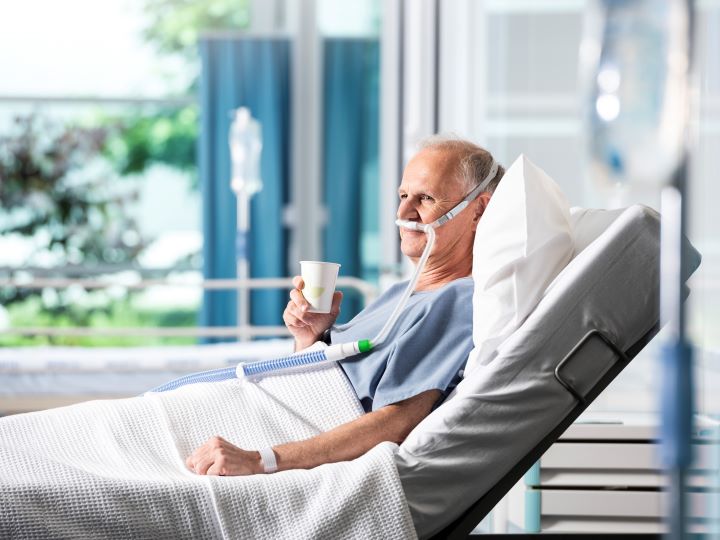 Patient sitting comfortably in hospital using Optiflow